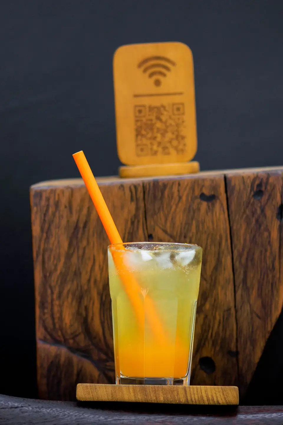 A golden iced drink below the carved wooden free WiFi sign at KTS Café